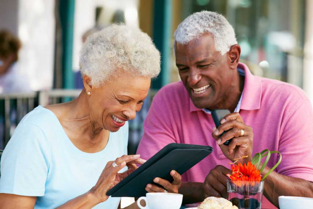 right age to join retirement community - senior couple using tablet